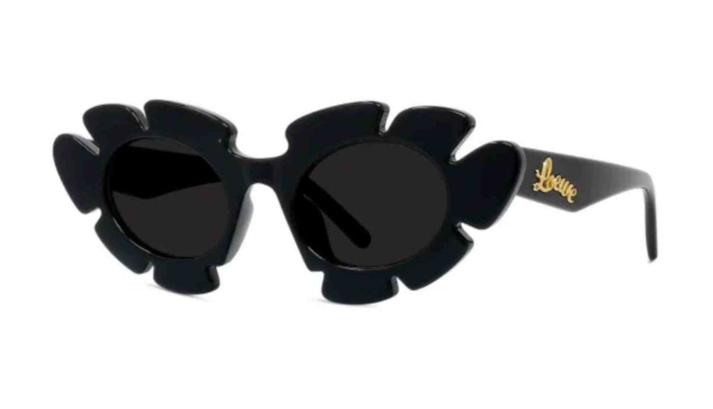 Shiny Black Loewe Curvy LW40088U sunglasses, which feature sharp petaled frames, dark lenses, and the brand logo in gold