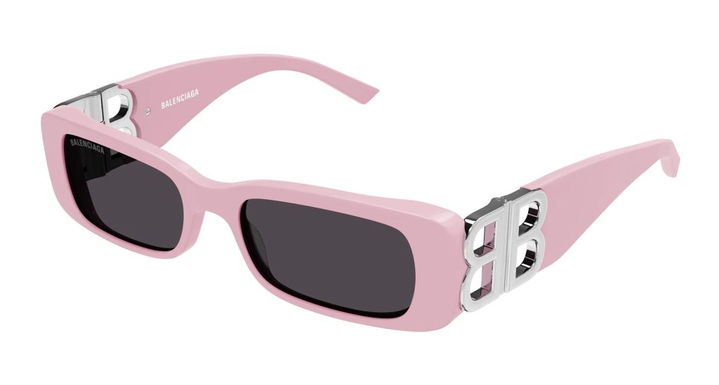 Statement Balenciaga BB0096S sunglasses featuring pink frames, grey lenses, and silver logo embellishments on the arms