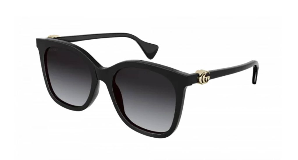 Black Gucci GG1071S oversized sunglasses with grey lenses and gold logo embellishments on the arms